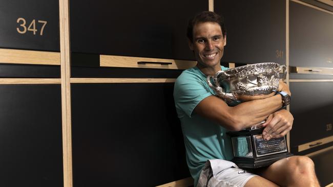 Rafael Nadal poses with the Australian Open men's singles final trophy in the locker room following his win at Melbourne Park.