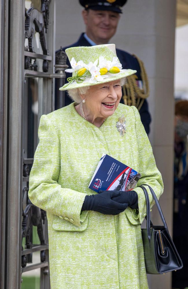 The Queen wore a wattle brooch and lime green outfit as she attended the ceremony to mark the Centenary of the Royal Australian Air Force at the Commonwealth War Graves Commission Air Forces Memorial in Runnymede, Surrey. Picture: Steve Reigate / Pool / AFP