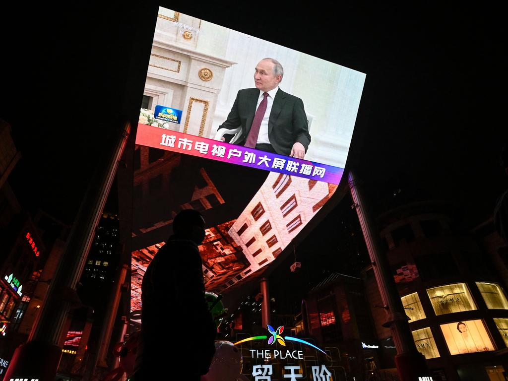 An outdoor screen along a street in Beijing shows live news coverage of Xi Jinping’s meeting with Vladimir Putin in March. Picture: Jade Gao/AFP