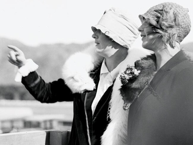 Laura Hood (left) and Dorothy Moncrieff, wives of aviators George Hood and John Moncrieff, wait for their husbands to land at Trentham, New Zealand.