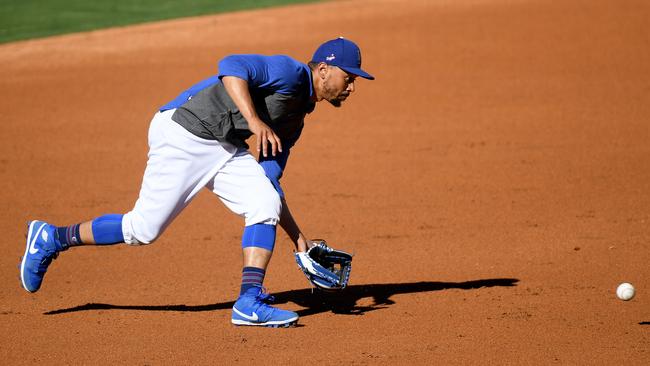 Mookie Betts fields a ground ball at a summer workout. (Photo by Harry How/Getty Images)