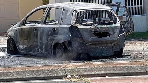 The charred remains of a car in Parkwood. Picture: Scott Kilgour