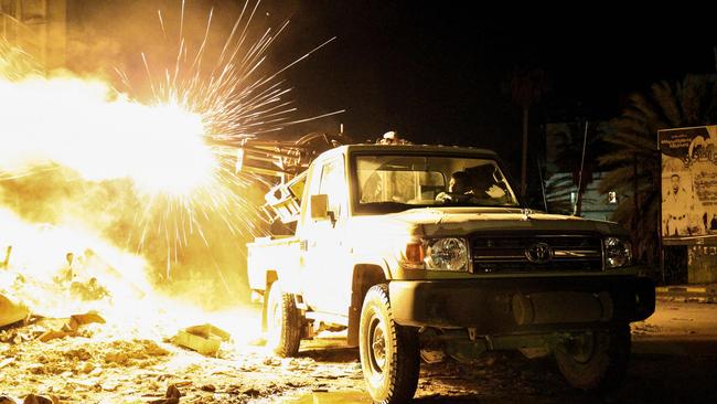 A member of the Libyan National Army (LNA) fires a machine gun mounted on the back of a Toyota at jihadists in district of Suq al-Hut in the eastern coastal city of Benghazi in 2017.