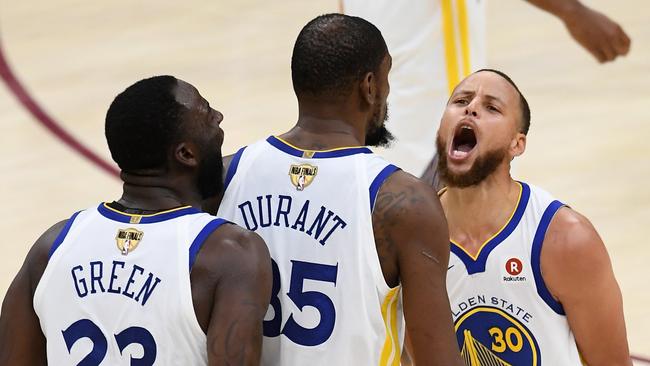 CLEVELAND, OH - JUNE 06: Stephen Curry #30 and Draymond Green #23 of the Golden State Warriors celebrate with Kevin Durant #35 against the Cleveland Cavaliers in the second half during Game Three of the 2018 NBA Finals at Quicken Loans Arena on June 6, 2018 in Cleveland, Ohio. NOTE TO USER: User expressly acknowledges and agrees that, by downloading and or using this photograph, User is consenting to the terms and conditions of the Getty Images License Agreement. (Photo by Jason Miller/Getty Images) *** BESTPIX ***