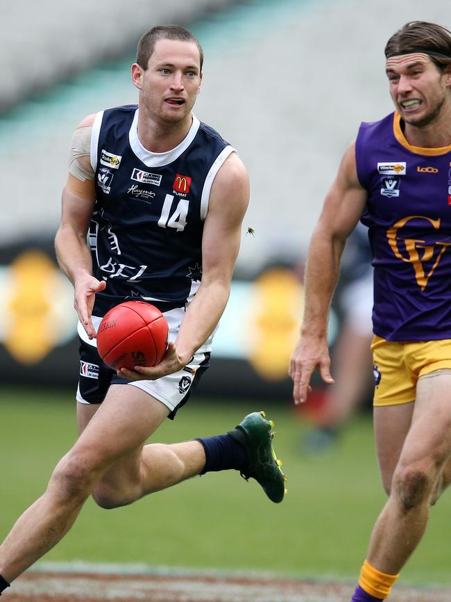 Ballarat’s Lachlan Cassidy looks for an option as he is chased by Jason Cole. Pic: Michael Klein