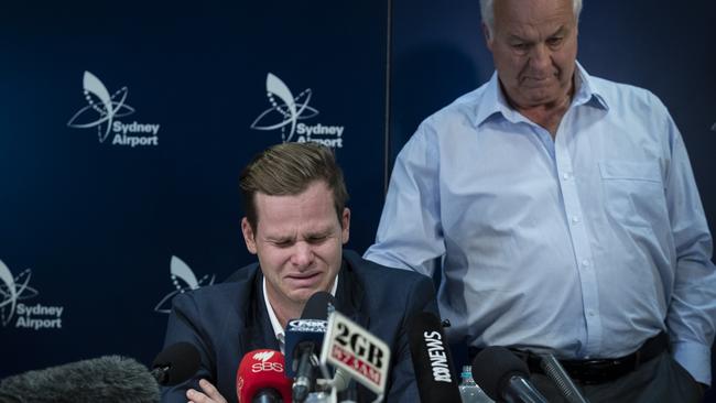 Dumped Australian captain Steve Smith is comforted by his father Peter at the press conference at Sydney airport on Thursday night.