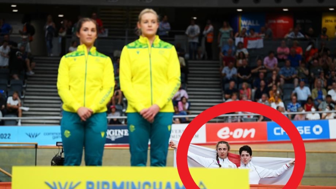Sophie Unwin and Georgia Holt of Team England stand with their flag behind the podium. Photo by Justin Setterfield/Getty Images.