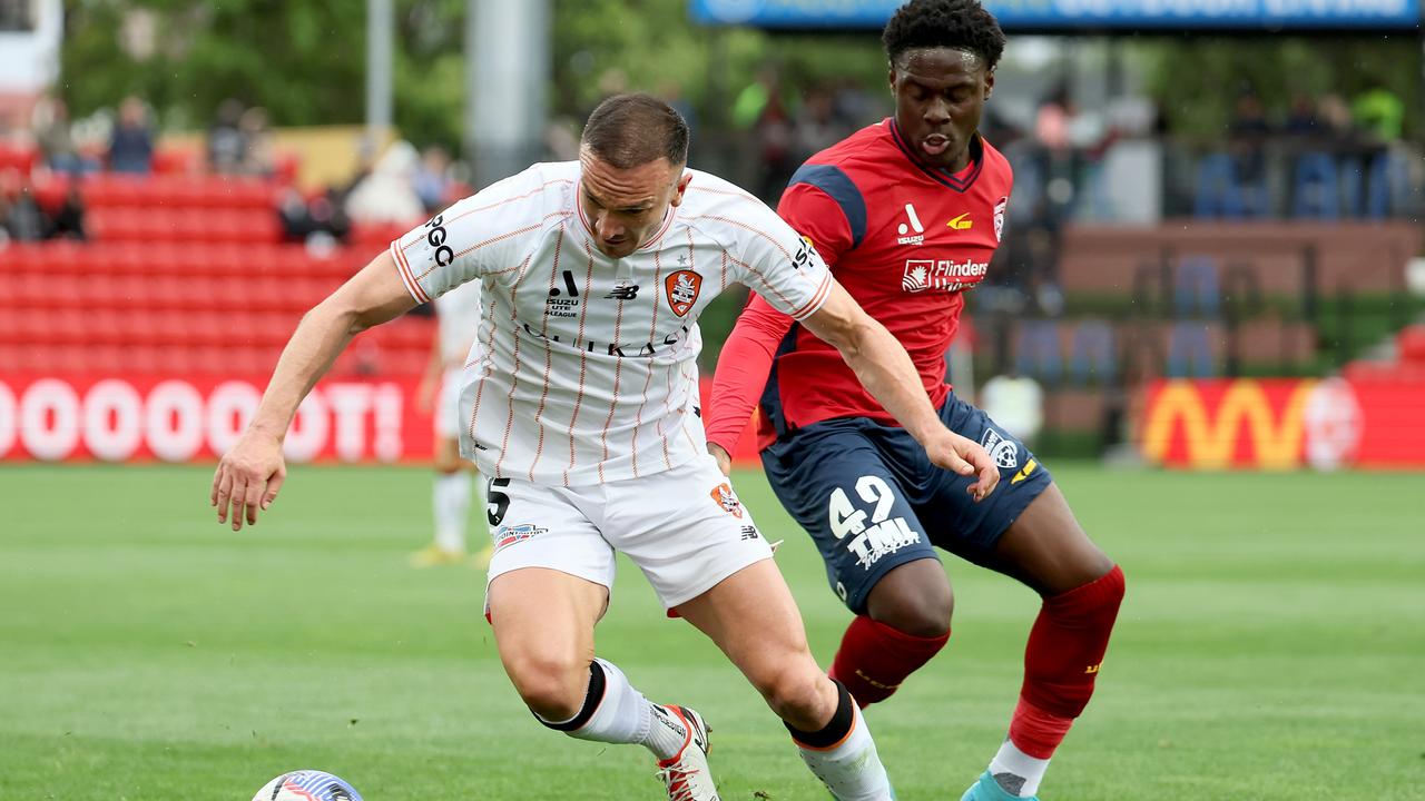 Tom Aldred of the Roar is tackled by Musa Toure of United. Picture: James Elsby/Getty Images