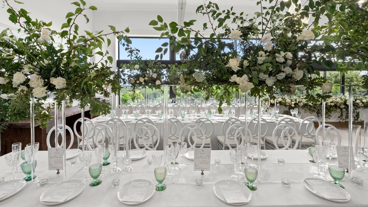 The outdoors was brought inside with trees, incredible greenery and white florals complemented by green crystal drinkware on crisp white tablecloths. Picture: Joey &amp; Jase