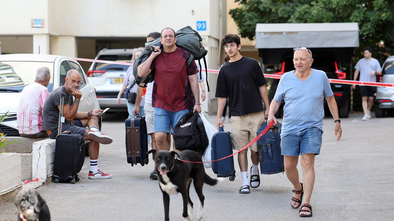 Residents leave their homes in Tel Aviv after a barrage of rockets were fired. Picture: AFP