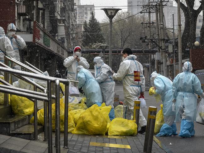 Chinese health workers in protective suits where a recent case of Covid was found on March 17, 2022 in Beijing, China. Picture: Kevin Frayer/Getty Images.