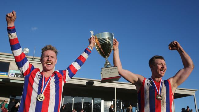 Lindenow South coach Nathan Pollard, left, and Sam Howden lift up the premiership cup after beating Swifts Creek in the grand final. Picture: Yuri Kouzmin