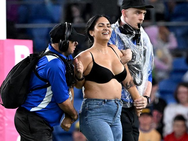 GOLD COAST, AUSTRALIA - APRIL 09: A pitch invader, Streaker, Javon Johanson, is taken from the field by security guards during the round five NRL match between the Gold Coast Titans and the Parramatta Eels at Cbus Super Stadium, on April 09 2022, in Gold Coast, Australia. (Photo by Bradley Kanaris/Getty Images)