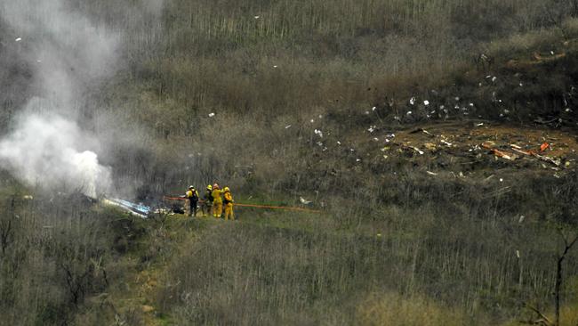 Firefighters at the scene of the deadly crash in Calabasas. Picture: AP