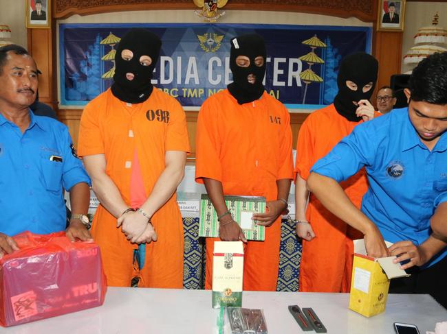 Isaac Roberts was brought into a media conference today in Bali wearing a black balaclava over his head and bright orange prison shorts and shirt. Picture: Lukman Bintoro