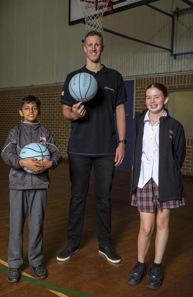 Sydney Kings basketball coach Daniel Kickert talks about the importance of attending schools with Vipra Jethwa (left) and Emma Humphreys, both 12, at Rouse Hill High. Picture: Christian Gilles