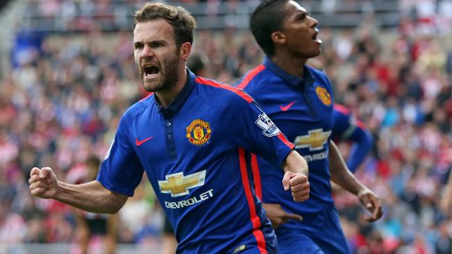 Manchester United's Spanish midfielder Juan Mata (L) celebrates.