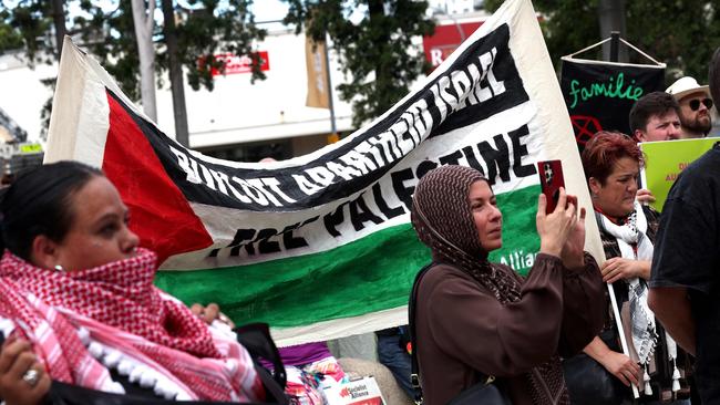 Protesters hold placards and banners during an ‘anti-racism rally’ in western Sydney. Picture: AFP