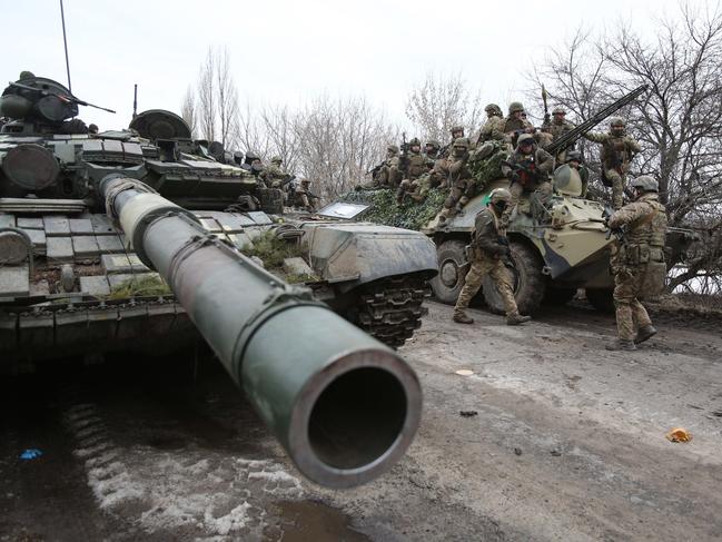 Ukrainian servicemen get ready to repel an attack in Ukraine's Lugansk region as Russia invades. Picture: AFP