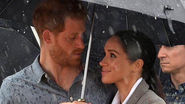 Prince Harry and Meghan, Duchess of Sussex managed to look adorable even during a downpour in Dubbo. Picture: Peter Parks/AFP