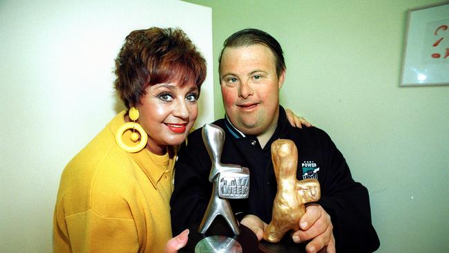 1997: Wills holding Logie award with artist Peter Burge holding model of Logie statuette her made at an art workshop for the intellectually disabled.