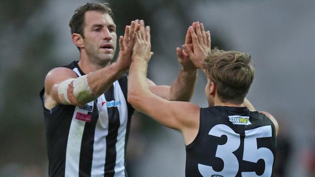 Travis Cloke celebrates one of his three first-quarter goals with a teammate in the VFL. Picture: Nathan Dyer