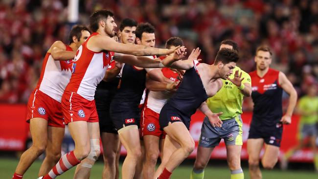 Swans players remonstrate with Melbourne's Tomas Bugg after an off the ball incident with Callum Mills. Picture: Michael Klein