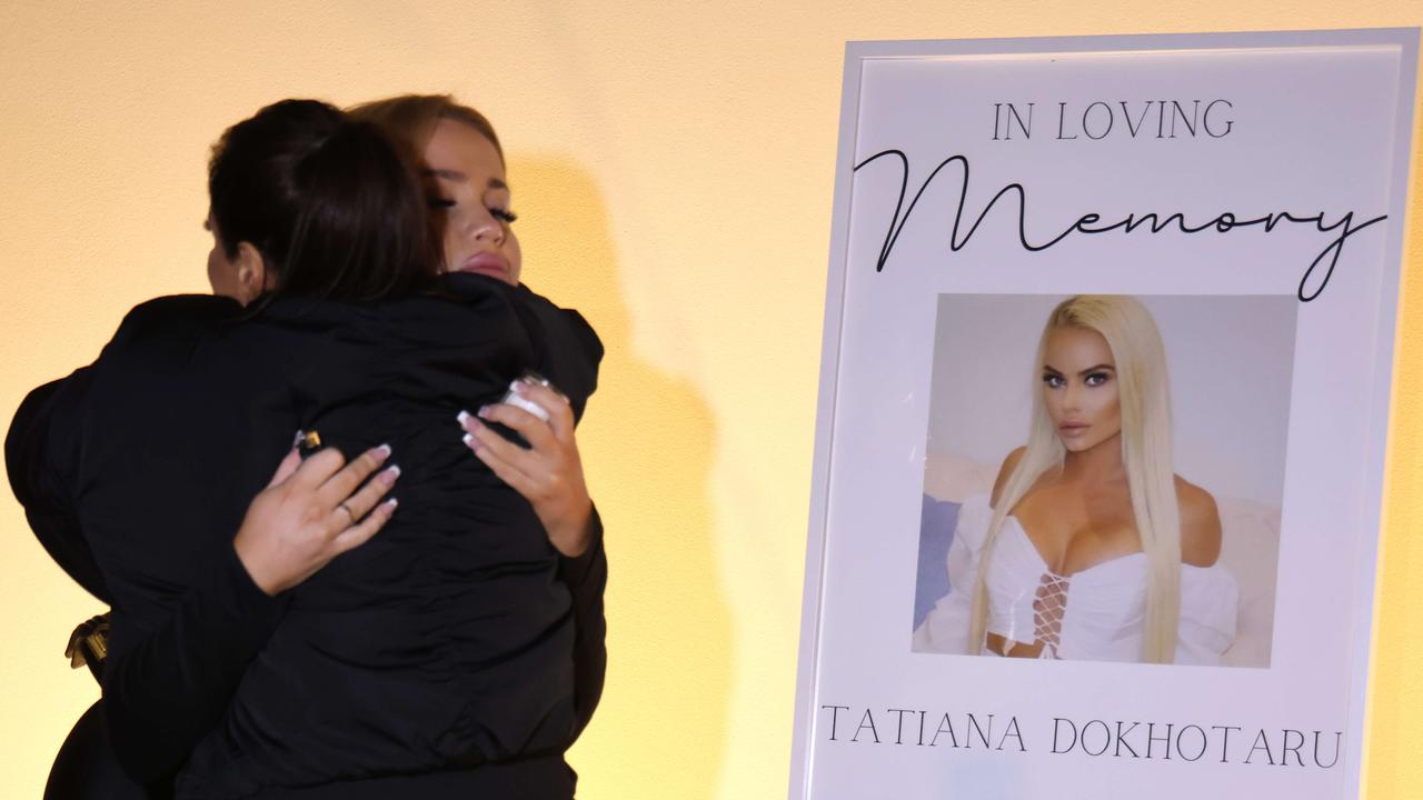 Mourners support each other at a candle vigil for Ms Dokhotaru. Picture: Damian Shaw