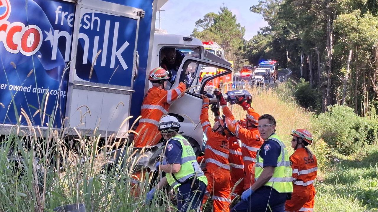 A Norco milk truck and a ute have collided on a major roadway at Nana Glen near Coffs Harbour, with emergency services workers frantically trying to free the trapped truck driver. Picture: Toni Moon.