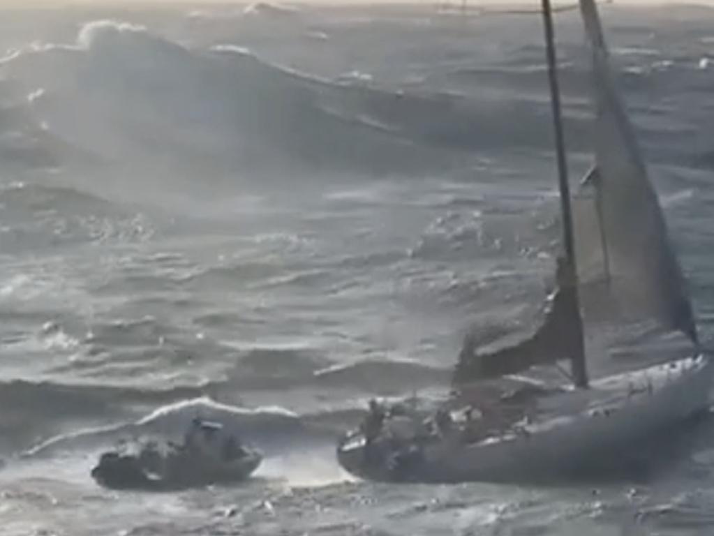 Rescuers reach a yacht with two people onboard in rough seas off the New South Wales south coast on Tuesday morning.
The Australian Maritime Safety Authority said it had received a distress beacon alert about midday on Monday from a vessel 185km east of Nowra. Media reports named the stricken 19-metre yacht as the Spirit of Mateship. Picture: NSW Police