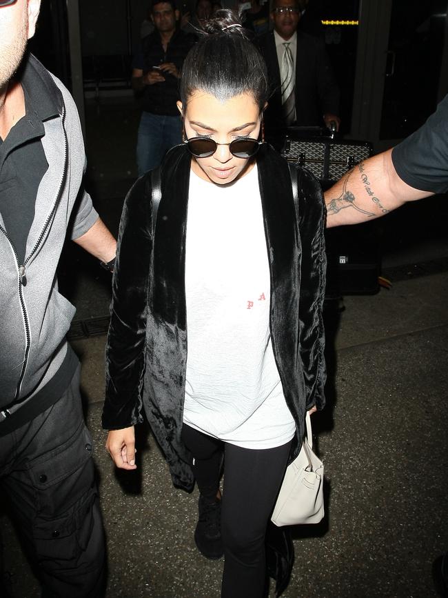 Kourtney Kardashian arrives at LAX airport surrounded by security on October 3, 2016. Picture: Splash