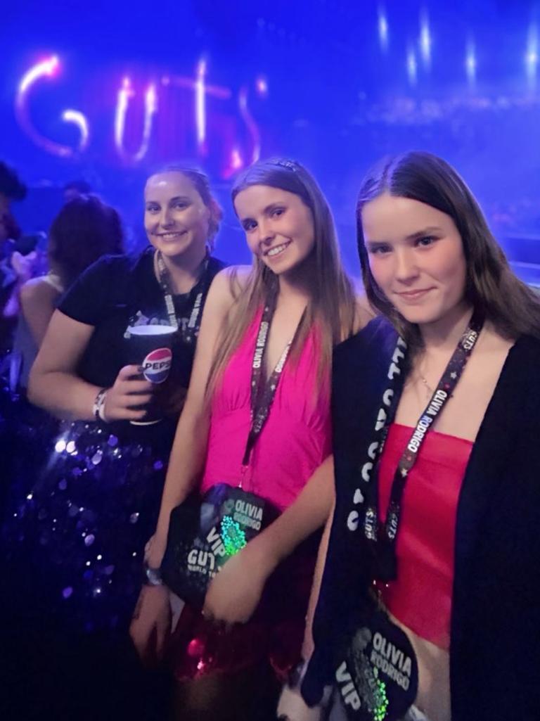 Sisters Emily, Chloe, and Imogen McAloon at the Olivia Rodrigo concert in Melbourne after shelling out a second time for tickets.