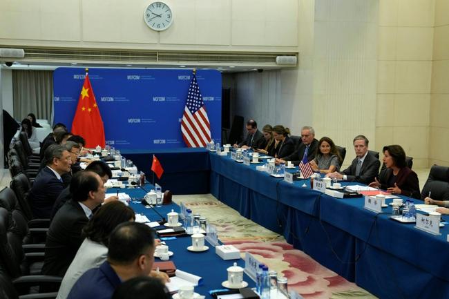 US Commerce Secretary Gina Raimondo (R) met with Chinese Minister of Commerce Wang Wentao (centre-L) in Beijing