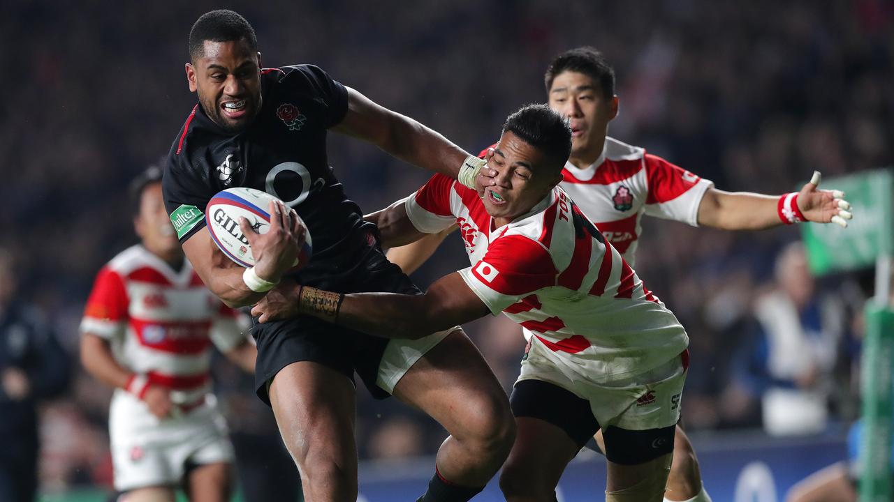 Joe Cokanasiga of England tries to fend off Kenki Fukuoka of Japan.