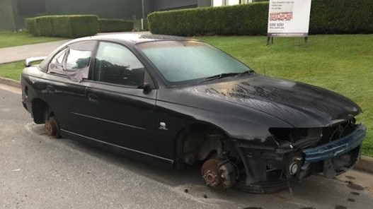 The stripped car has been sitting outside of the Southport business block for over two weeks. 