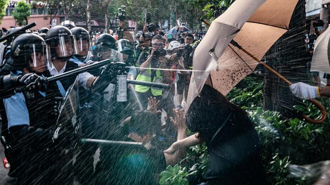 Police spray protesters with pepper spray in Sheung Shui district of Hong Kong on Saturday. Picture: Getty Images