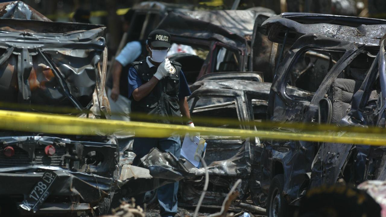 An investigator works amid the rubble of the Sari Club in Kuta, Bali, as efforts continued to identify the victims. Picture: Getty Images)