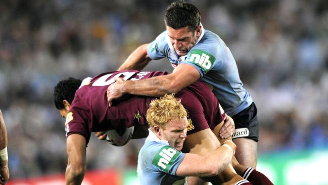 Peter Wallace and Danny Buderus make a tackle during a 2008 Origin match. Wallace played four Origins for NSW. Picture: Craig Wilson