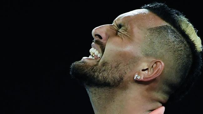 Nick Kyrgios reacts after a point against Rafael Nadal during their men's singles match on Monday night. Picture: Saeed Khan/AFP