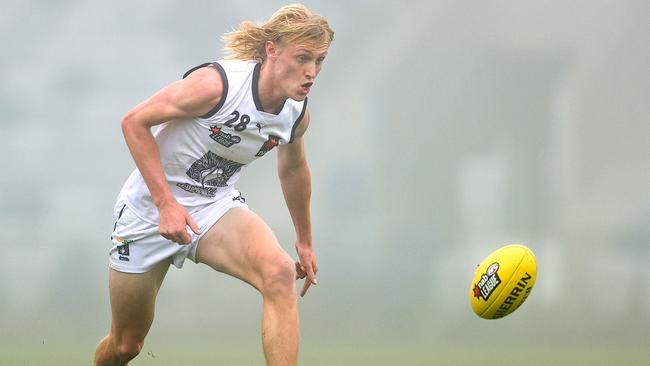 Mitchell Knevitt of the Falcons chases the footy through the fog at Mars Stadium.