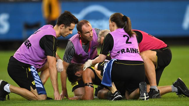 Trainers tend to Richmond’s Alex Rance after he suffered an ACL injury in Round 1. Picture: Julian Smith. 