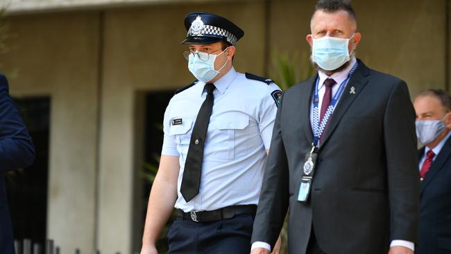 Constable Zachary Schembri (pictured) &amp; Constable Shane Warren leave the Townsville Courthouse after giving evidence at an inquest. Pictured with Queensland Police Union representative. Picture: Alix Sweeney