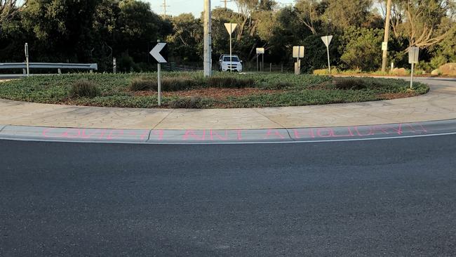 Graffiti saying “Covid-19 ain’t a holiday”, on the roundabout at the corner of Old Melbourne and Canterbury-Jetty roads, Rye.