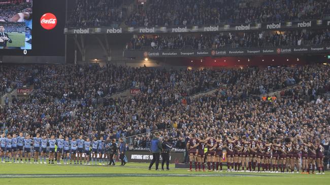 NSW and Queensland players line up for the national anthem before Game Two of the 2018 State of Origin series. Picture: AAP