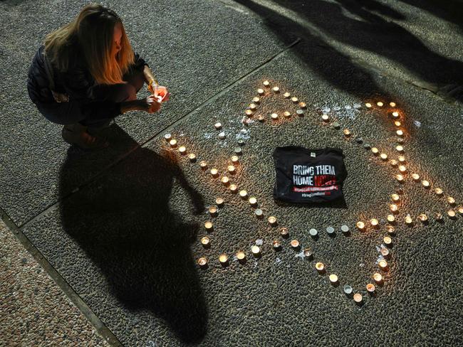 A woman lights candles during a gathering in Tel Aviv demanding the release of Israelis held hostage in Gaza since the October 7 attack by Hamas militant. Picture: AFP