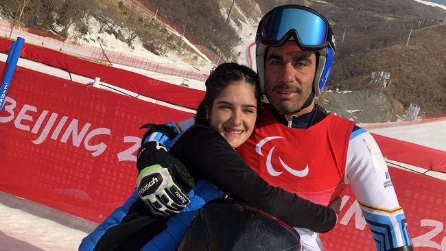 Argentinian alpine skier Enrique Plantey (R) and his Spanish girlfriend Triana Serfaty (L) pose for photos after a race during the Beijing 2022 Winter Paralympic Games at the Yanqing National Alpine Skiing Centre in Yanqing on March 10, 2022. – He is the 