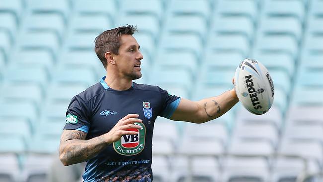 NSW Blues player Mitchell Pearce with a ball during the final run before tomorrow’s match.