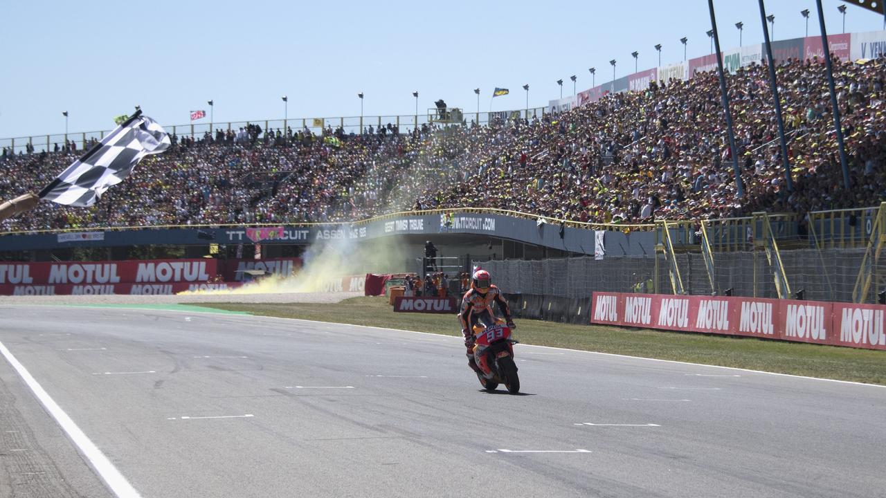Marc Marquez cuts the finish lane and celebrates his 2018 Assen win.