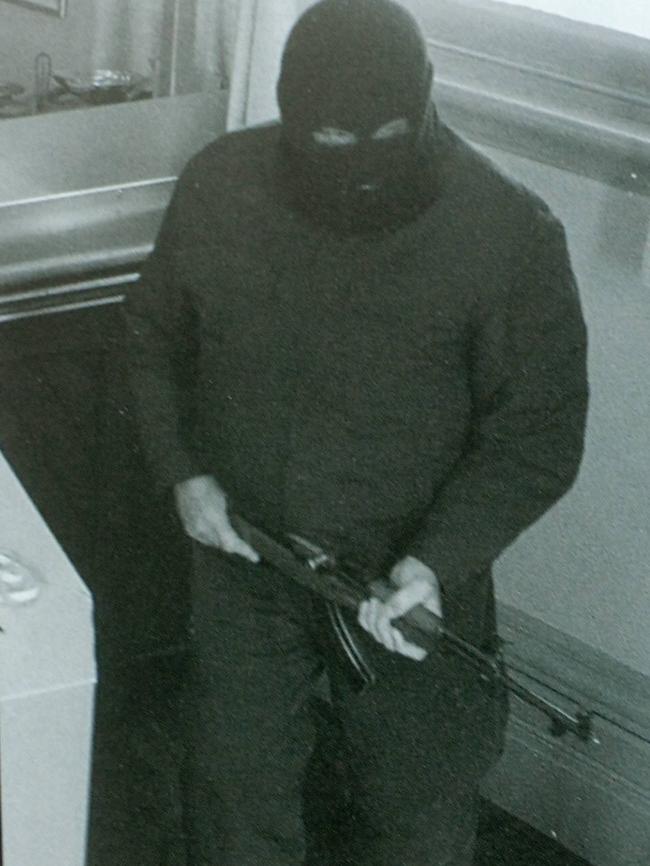 The notorious Adelaide Hills bank-robbing Bicycle Candit, wearing a balaclava and carrying a gun, captured on security cameras.