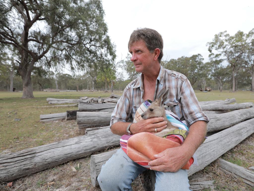 Mark Reiser with joey Emily (10 months) had to evacuate his Deepwater property. Picture: Mark Cranitch